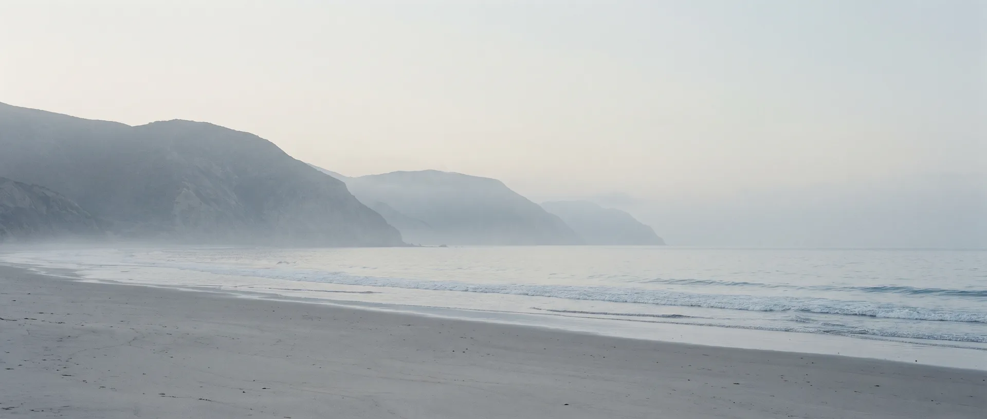 The Southern California coastline looking along the shore, headlands receding into morning haze