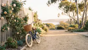 A child's bicycle leaning against a garden fence in late afternoon light