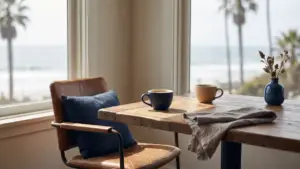Two coffee cups on a cafe table by a window