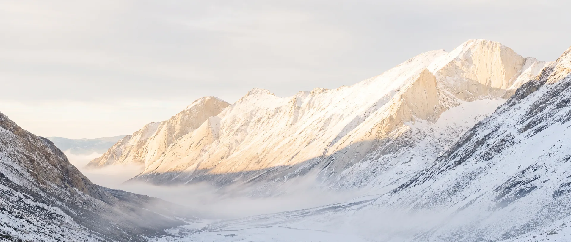 First light on a mountain ridge above a quiet valley