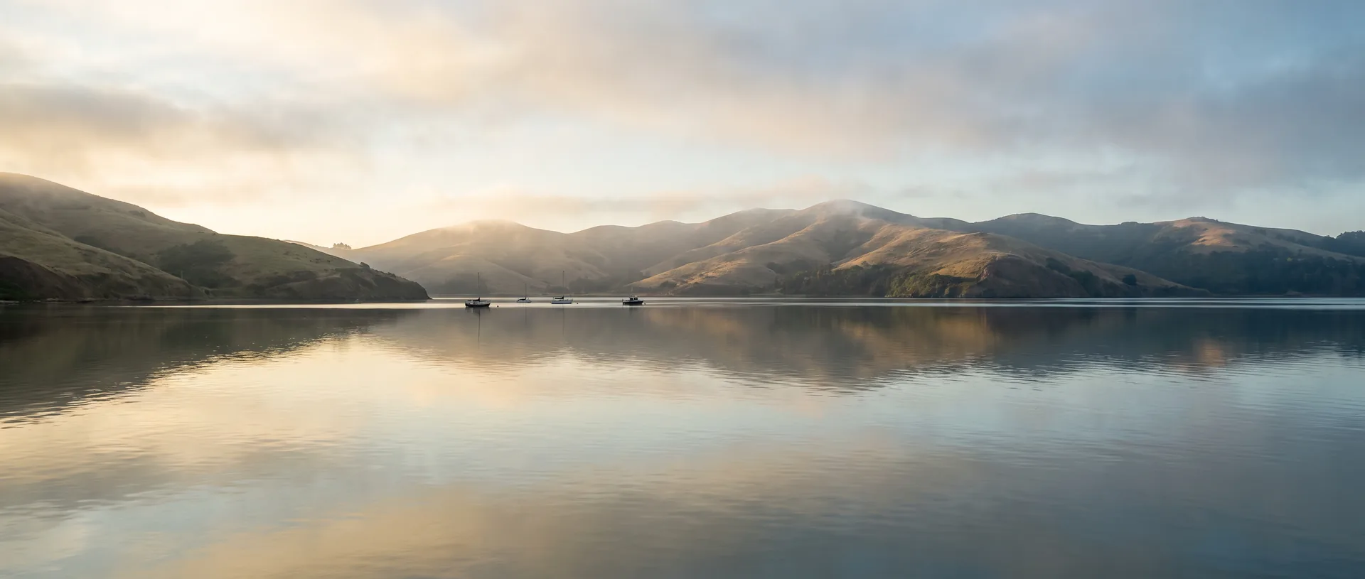Fog lifting off a northern California bay at dawn